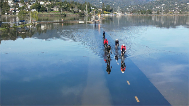 Bicyclists riding on flooded bike path in Marin County