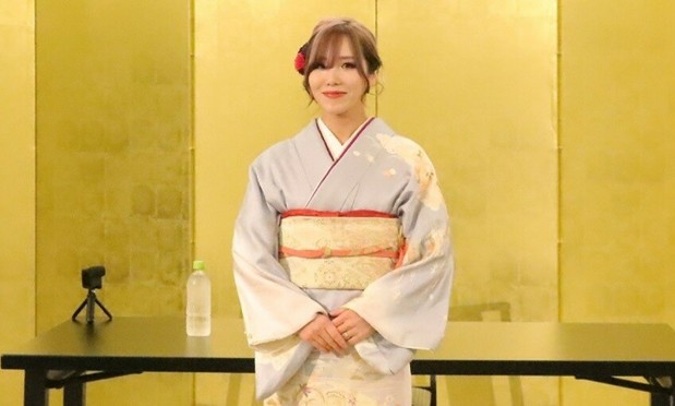 Joshi wrestler KAIRI in a grey kimono at her press conference