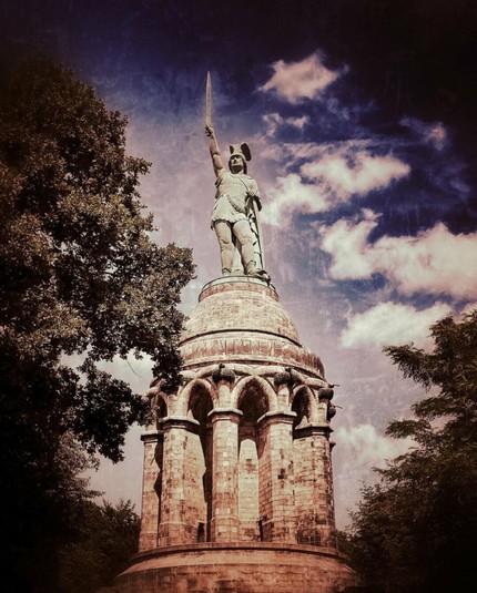 Germany‘s highest statue, Arminius the Cheruscan, raises his sword into the air. Edited with dramatic sky patterns. Detmold, Germany.