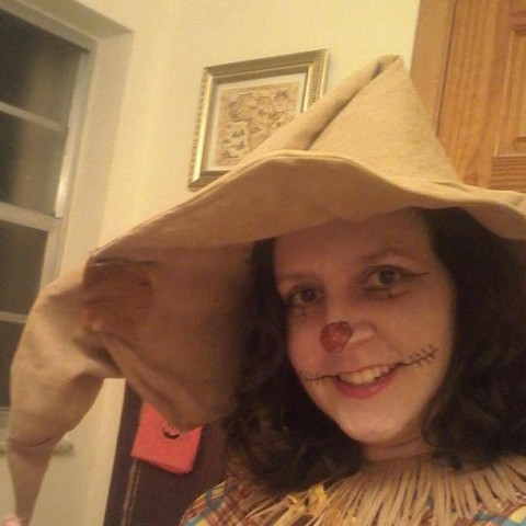 An old photograph of a woman dressed in scarecrow regalia.