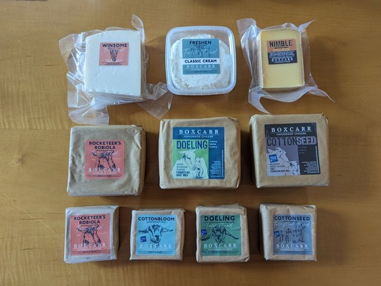 Boxcarr Cheese assortment: two hard cheeses, and a cream cheese; three fullsize soft cheeses; four mini soft cheeses. A mix of goat and cow's milk cheese.