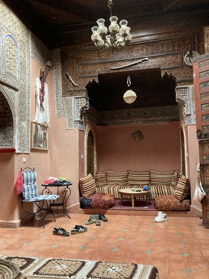 Another view of the beautiful open living space, original tiles and low Moroccan sofas, ornate tile work, the kind of place you might lie around smoking hashish or reading texts to uncover holy relics