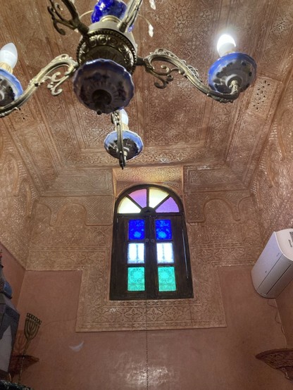The interior of a 16th C ryad we’re staying in for a while - High ceilings and densely tiled & decorated with Arabic phrases and patterns - this one shows a high strained glass window in one of the bedrooms