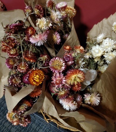 Flower bouquets in brown wrapping paper.