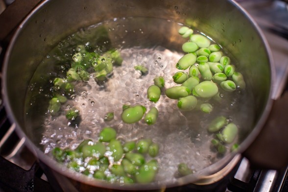 Pale green seeds floating in boiling water.