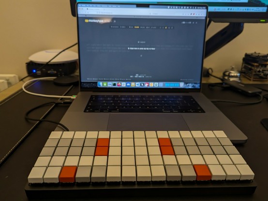 Hobbyist stenography keyboard infront of a MacBook pro showing Monkeytype.