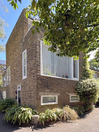 A colour photograph of a brick mews house in Primrose Hill