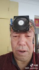 a selfie taken by an old man with a cpu cooler strapped to his forehead