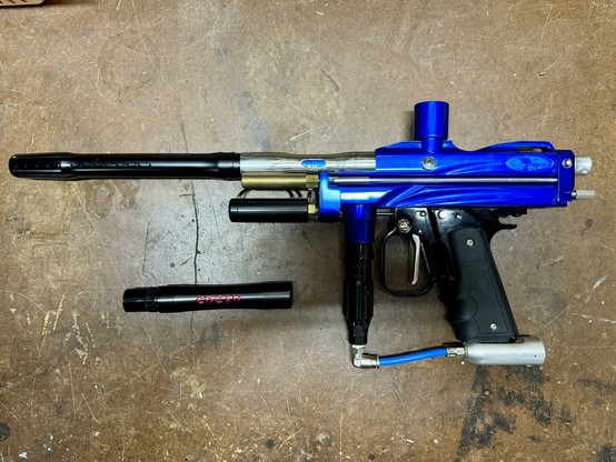 A blue 2003 WGP Autococker Prostock, fully assembled, with barrel, on a workbench