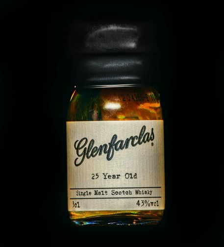 A square photograph of a 3cl bottle of whisky, with a tan label and sealed with black wax. The bottle is labeled "Glenfarclas 25 Year Old Single Malt Scotch Whisky" and states the 3cl volume and 43% ABV of the liquor.