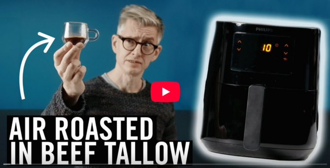 screenshot of a youtube video still: James Hoffmann holds up a glass cup of coffee, looking sceptical, next to him a black Philips air frying machine is pictured. Text: Air roasted in beef tallow