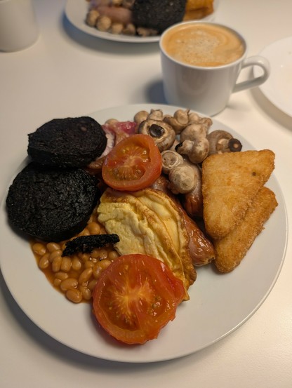 Breakfast; bacon, sausage, beans, egg, black pudding, hash browns, mushrooms & grilled tomato.
Served with coffee