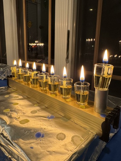 My oldest son fully lit oil menorah