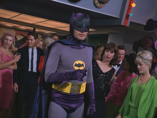 "Gleeps, it's Batman!" The Caped Crusader visits the What A Way To Go-Go discothèque located on 222 Glover Avenue, Gotham City.