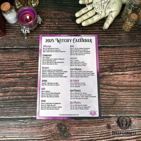 A 2025 Witchy Magnet Calendar is laid flat on a wood tabletop. It's white with a purple graphic border with sections for each month. There are 3 to 5 events listed for every month, including moon phases, other astrological events, and sabbats. This is an exclusive product from Inked Goddess Creations.