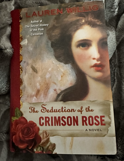 the cover of The Seduction of the Crimson Rose by Lauren Willig, part of her Pink Carnation series. It’s a historical romance novel with espionage, intrigue, and plenty of drama!