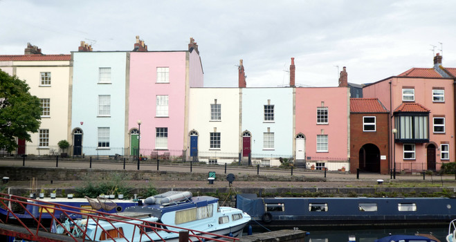 A row of painted houses, on the harbour front.