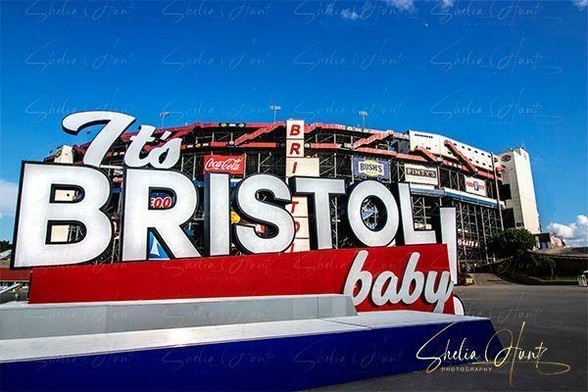 Bristol Motor Speedway on a blue sky day at Bristol, Tennessee. Its slogan sign “It’s Bristol Baby!” is featured in the foreground. From the Fine Art Gallery of Shelia Hunt.