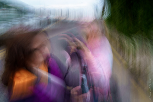 Abstract photograph of two figures, with bright colours and a blurred effect.