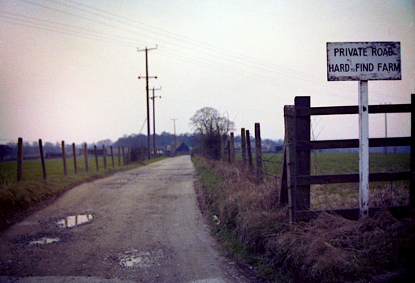 Farm lane with sign reading "PRIVATE ROAD HARDtoFIND FARM".