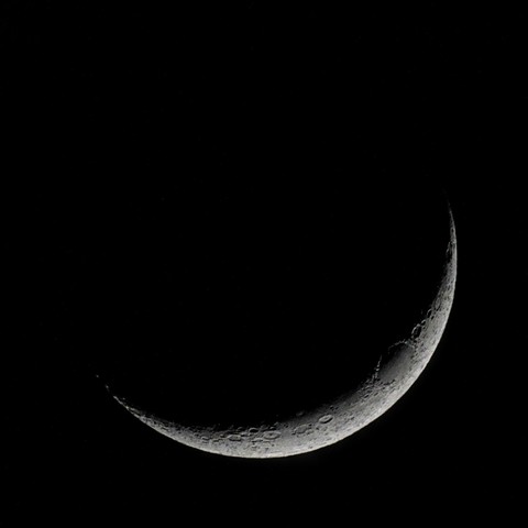 A photograph of a waxing crescent moon taken.