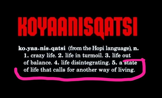 The image features bold red capital letters at the top stating "KOYAANISQATSI" against a black background. Below, in smaller white text, there is a definition structure explaining that "Koyaanisqatsi" is a term from the Hopi language. The definition lists several meanings: 1. crazy life, 2. life in turmoil, 3. life out of balance, 4. life disintegrating, 5. a state of life that calls for another way of living. A pink hand-drawn line underlines the fifth definition.