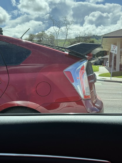 A moron colored Toyota Prius with a big spoiler.