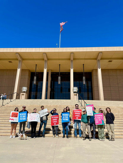 Same group same signs, with the portico and stairs viewed straight on