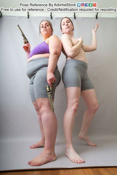 Two women, back to back, shot from a low angle, one holding two revolvers, both looking down at the camera.