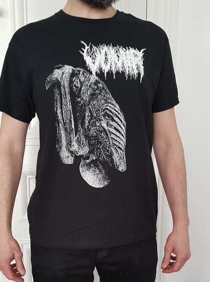 a man posing with a black t-shirt (on it is a strange creature, looking like a turkey with the carcass visible) Above it is the artist's Name (Vomir) in an almost unreadable font