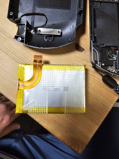 The battery witha very annoying little connector on a flex ribbon