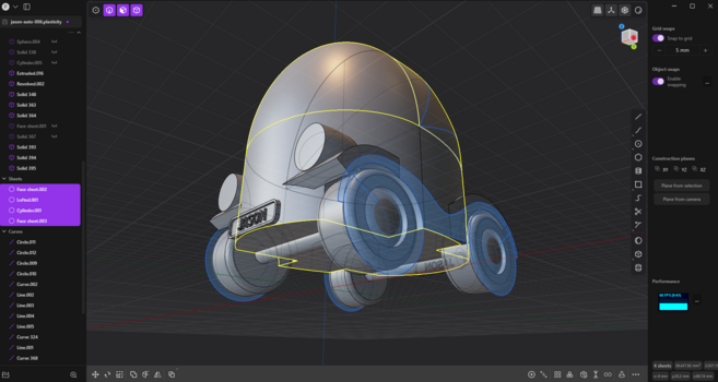 A 3D modeling software interface showing a futuristic, cartoonish car design. The car has a rounded, dome-like top and four large wheels with blue and yellow highlight lines indicating different geometry elements. The interface displays various tools, object lists, and construction planes, with 'Jason' visible on a front license plate. The design has a playful and sleek appearance, resembling a small compact autonomous vehicle.