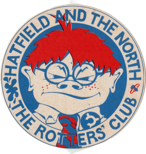 Hatfield and The North - The Rotters' Club (badge : blue lettering around a cartoon image - the face of a freckled bespectacled red-headed schoolboy with a wry smile squints at us accusingly)