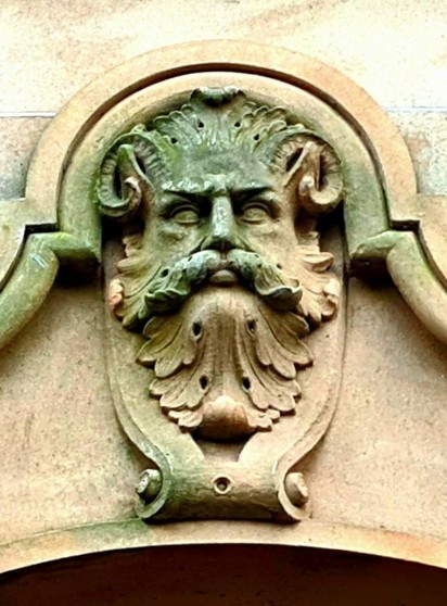 A mask of the Green Man on a Victorian building in Glasgow.