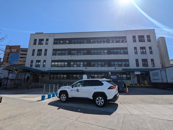 A four story building with a large loading dock.