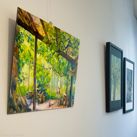Watercolor painting exhibited on a wall with other artworks.
