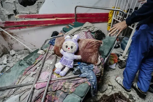 A doll on a destroyed bed in paediatric department in Nasser Hospital.
