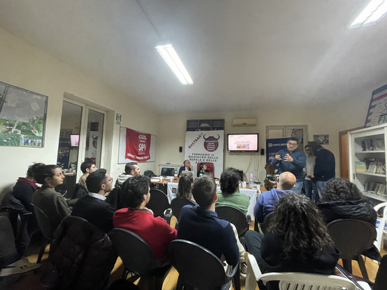 Persone sedute ad ascoltare la presentazione