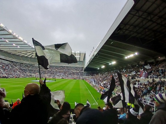 St james park from the gallogate end. It is full except for level 7. There are lots of black and white flags being used, having been put out by wor flags