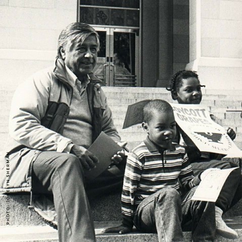 Historic black and white photo of Cesar Chavez with children. Photo by Jocelyn Sherman