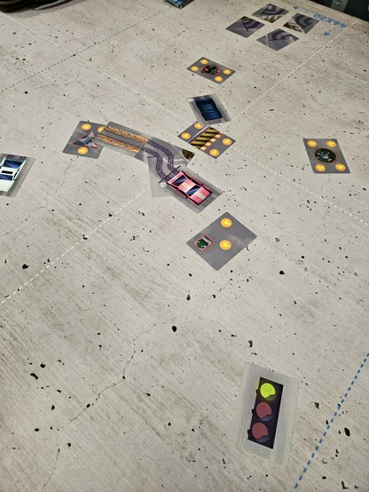 Turbo Drift. Cards depicting cars and various obstacles lay splayed messily on a table.