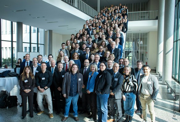 Over 220 Brazilian and German researchers posing for an group photo in Berlin at FAPESP Week on a stair.