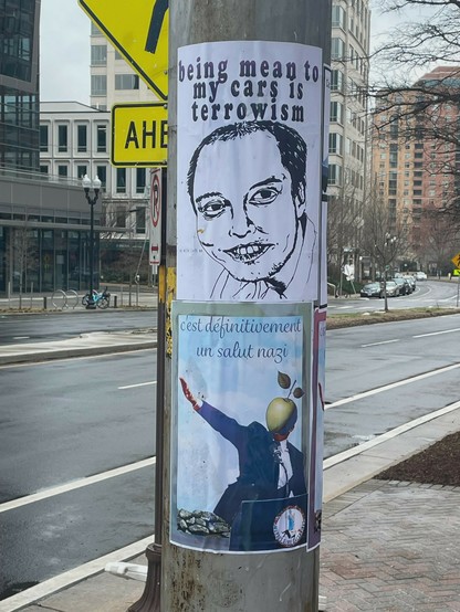 Anti-elon posters on a street pole.

Two posters. Top one is a drawing of Elon Musk pre-hair transplant, text: “being mean to my cars is terrowism”

Bottom poster shows a person with a green apple for a head (à la Magritte) giving a stiff-armed salute. Text: “c’est définitivement un salut nazi”the