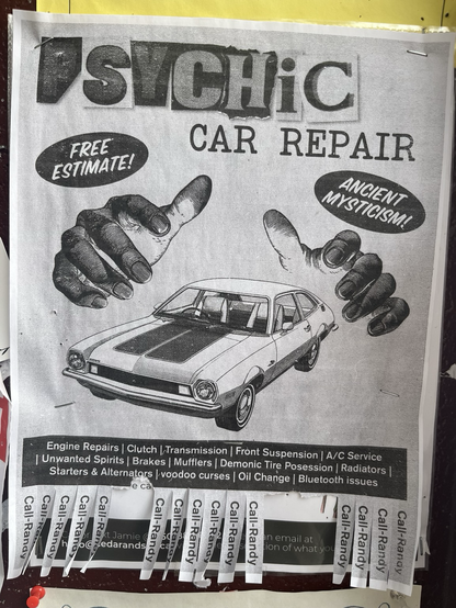 A poster advertising psychic car repair with hands hovering over a call. The pull tabs at the bottom say call Randy but have no number.