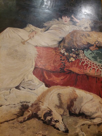 Tableau signé Georges Clairin disposé dans le hall du Grand-Hôtel Intercontinental de Paris on y voit au format vertical étendue nonchalamment sur un sofa Sarah Bernhardt tout habillée de blanc et à ses pieds en croissant de lune un Barzoï. « M. Clairin nous la représente enveloppée dans un long peignoir de satin blanc à queue traînante, elle est étendue sur un riche divan de satin rosé, et accoudée sur un coussin de même étoffe chamarrée d'or ; à sa droite et dans le fond de cet appartement tout oriental, est une glace de Venise entourée de rideaux de velours violet ; à sa gauche une plante tropicale abaisse ses larges feuilles vertes sur l'actrice et sculpteur en méditation ; à ses pieds, un lévrier jaune de grande race repose sur ses longues pattes et allonge sa tête fière et aristocratique » Théodore Véron, Le Salon de 1876.