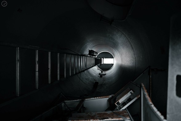 Shot up inside of wind turbine section showing ladder and scrap