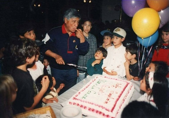 A historic photo of Cesar Chavez surrounded by his grandchildren and movement staff children at his birthday party at the UFWs La Paz HQ in Keene CA. Photo copyright Jocelyn Sherman