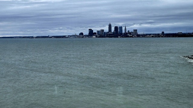 The skyline of Cleveland with the grey green lake Erie in the foreground