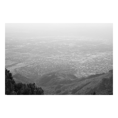 looking from top of mountain down to city grid far below