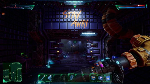 A video game screenshot in first person, looking down a long hallway. The player is holding a chunky yellow wrench, and directly ahead of them you can see the words "STAY AWAY" painted as yellow graffiti.